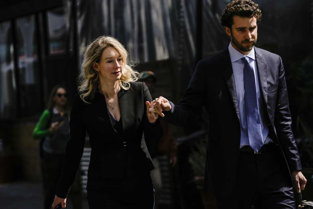 Former Theranos CEO Elizabeth Holmes and her partner, Billy Evans, following a hearing at the Robert E. Peckham U.S. Courthouse on March 17, 2023 in San Jose, California. Evans has raised millions of dollars for a new health tech startup that Holmes is advising him on.