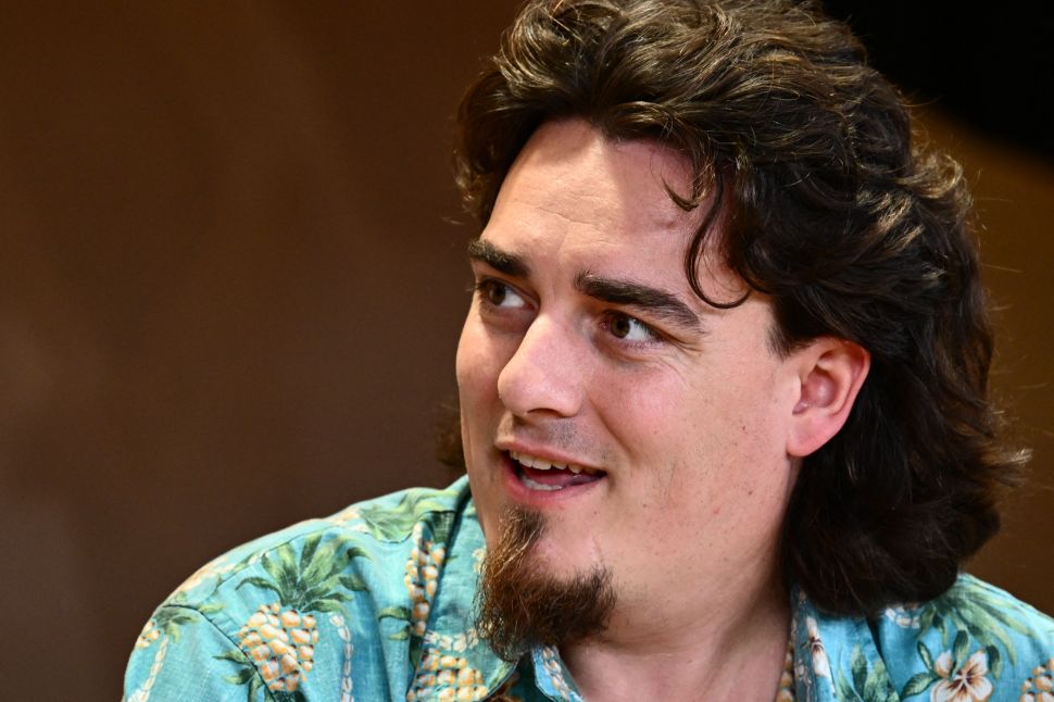 Image of man with goatee wearing patterned blue shirt