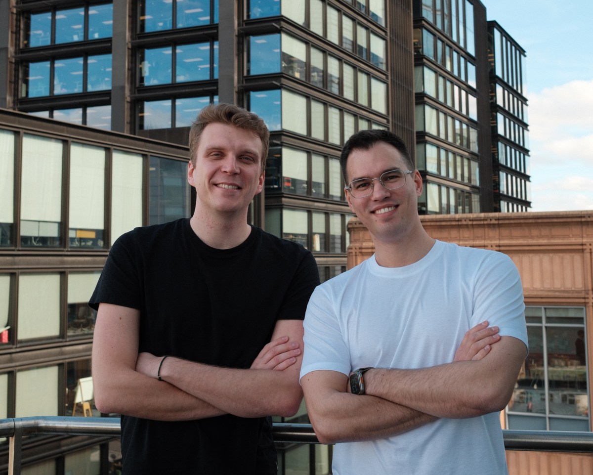 Trace founders Tim Cherkasov and Artur Romanov stand on a rooftop, crossing their arms