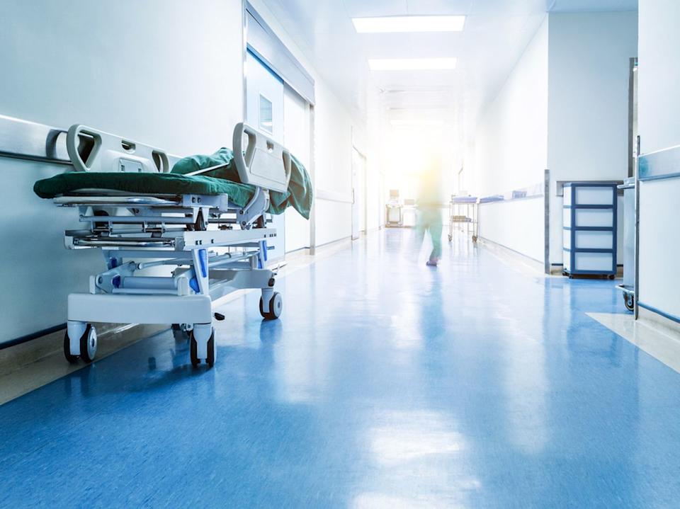 Doctors or nurses walking in hospital hallway, blurred motion