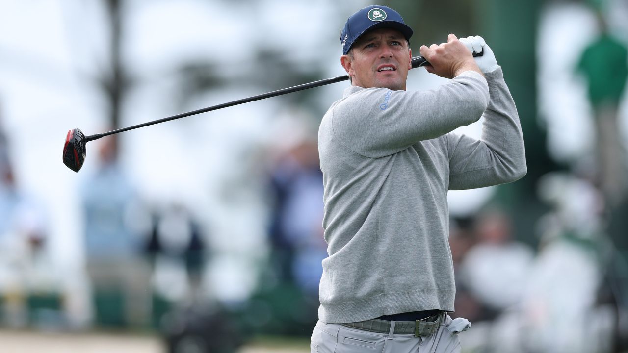 Bryson DeChambeau swings a golf club while the Sportsbox AI app captures his motion on a nearby sma...