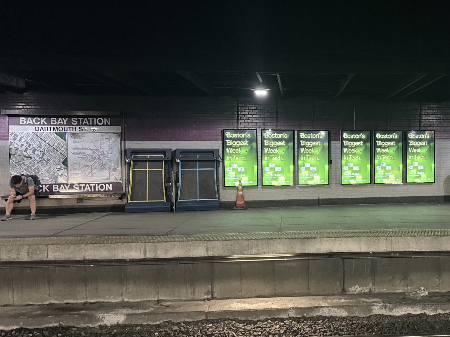 Advertisements for Boston Tech Week in the Back Bay MBTA station.