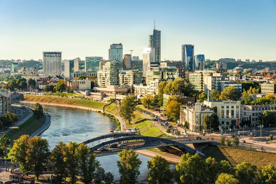 Lithuania, Vilnius, view to the modern city of Vilnius with Europa Tower and Neris River in the foreground