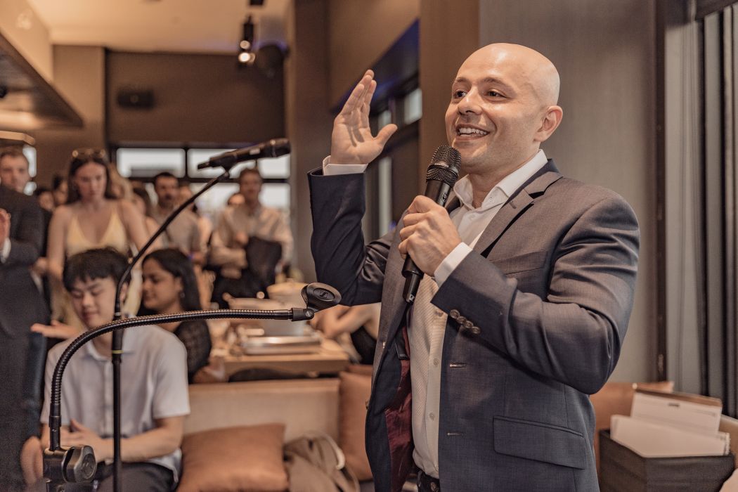 Fellow CEO Aydin Mirzaee speaks into a mic in an informal setting