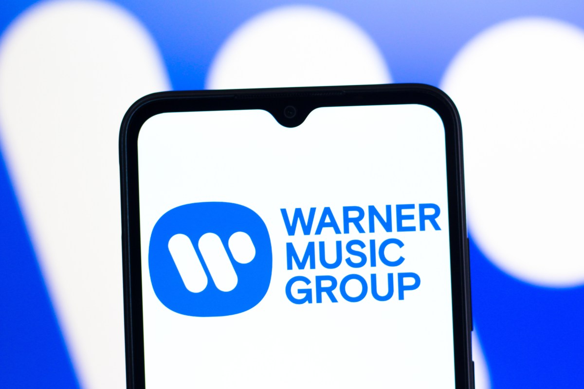 In this photo illustration, the Warner Music Group logo is seen displayed on a smartphone screen.