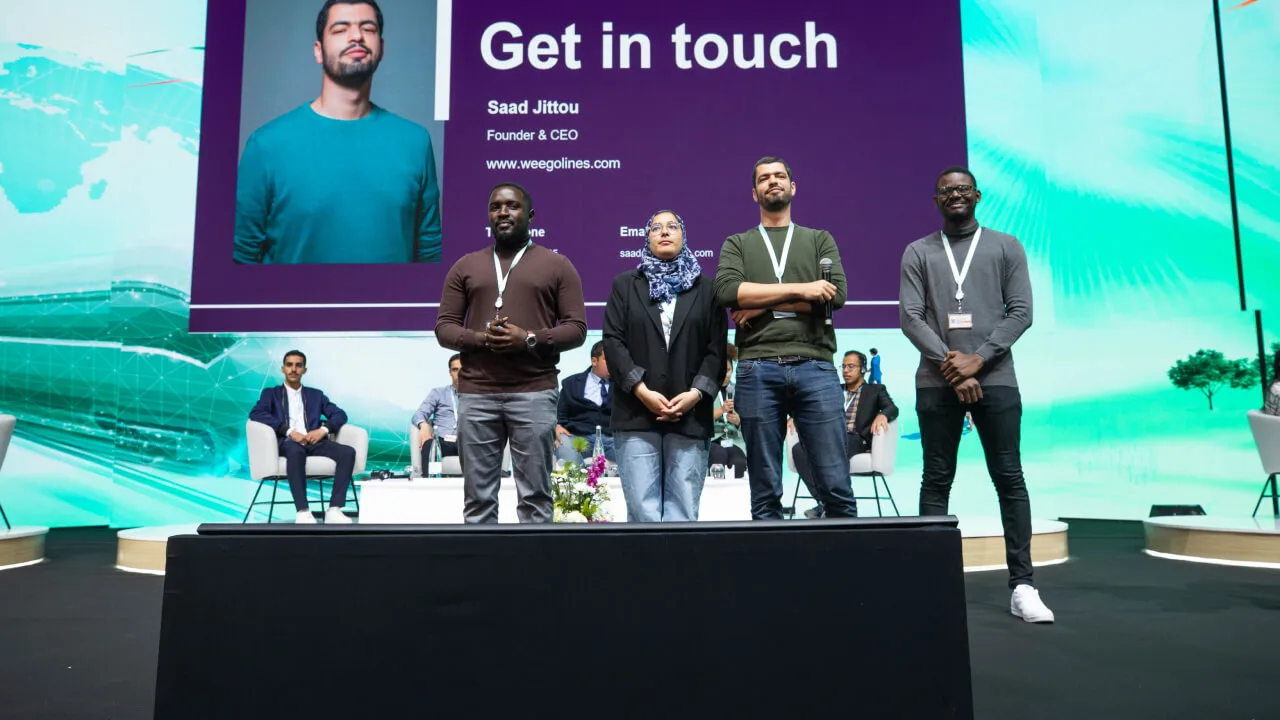 Weego Team on stage at an event.