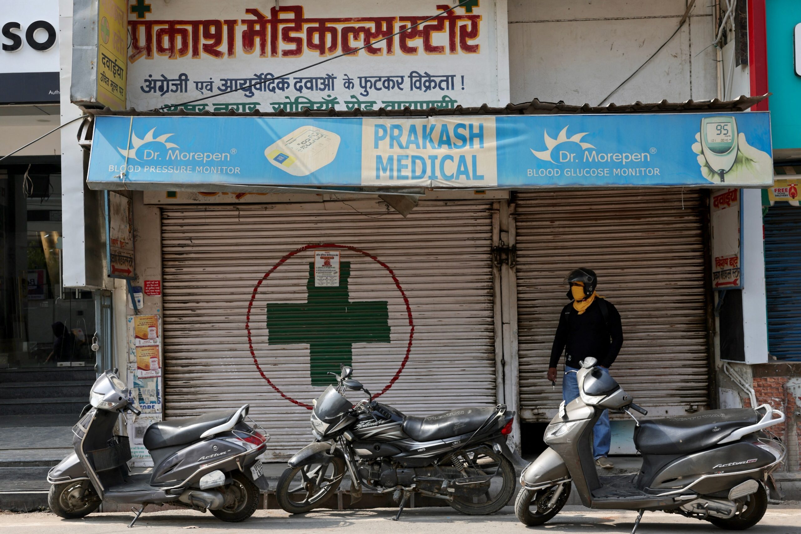man stands front closed chemist's shops nationwide