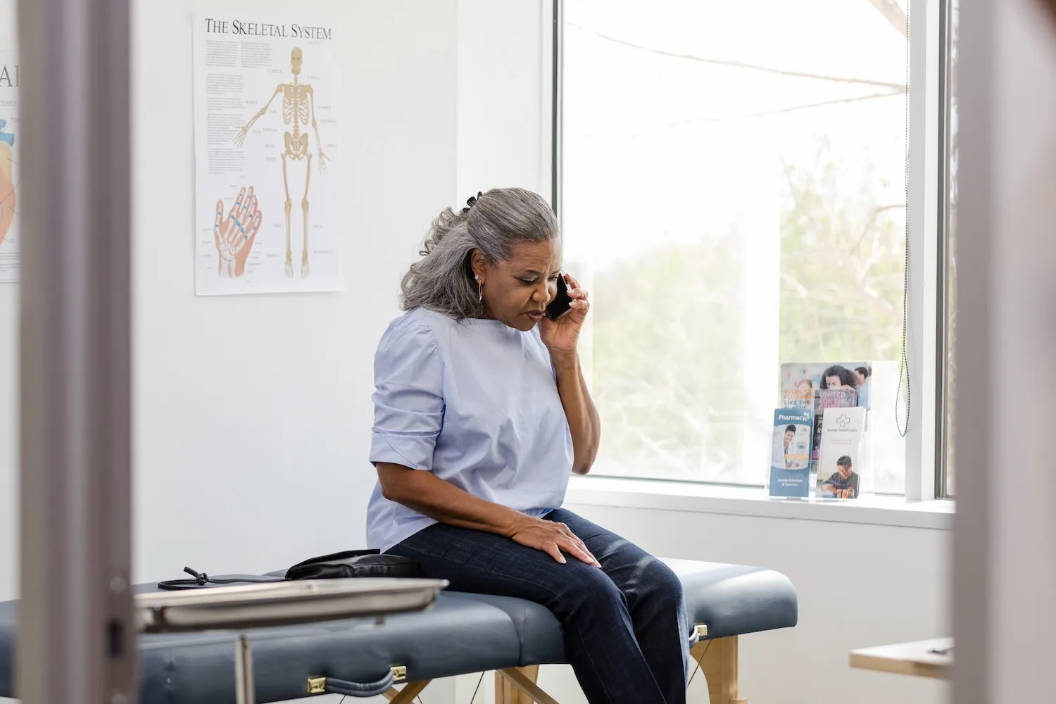 patient on phone at doctors office