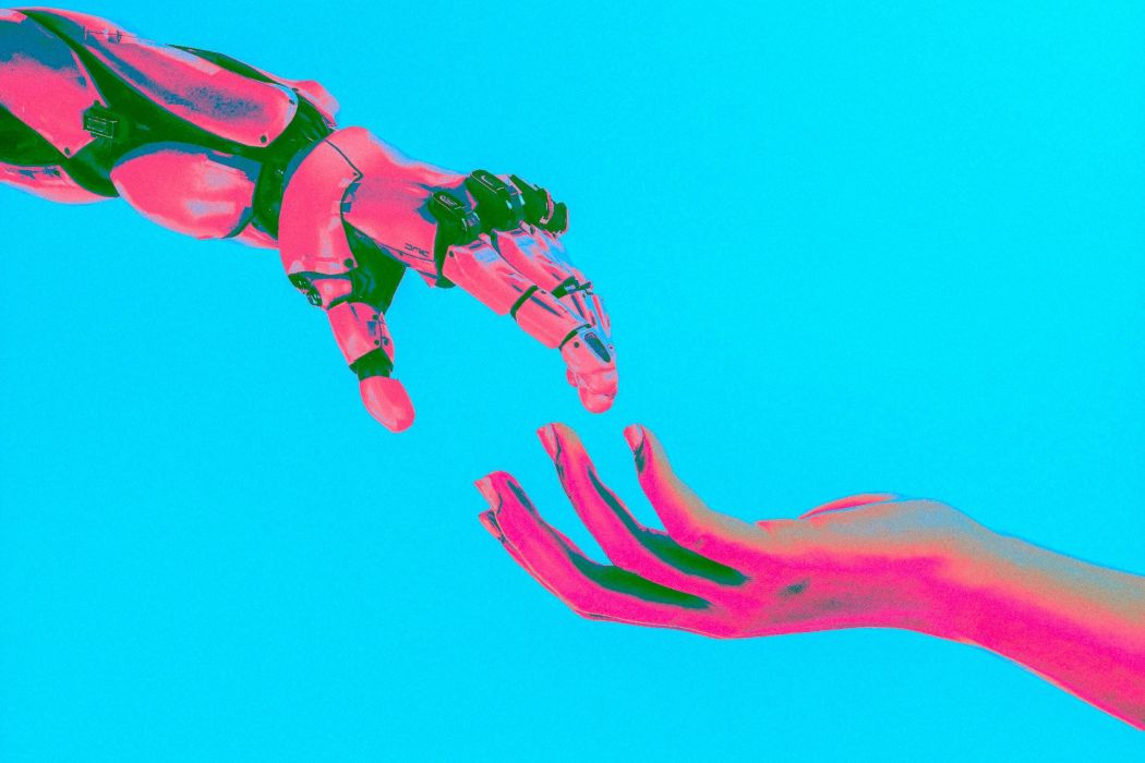 A robot and human hand reach out to each other