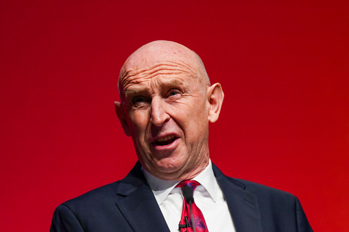 John Healey, the Chancellor, speaking against a red background about AI strategy.