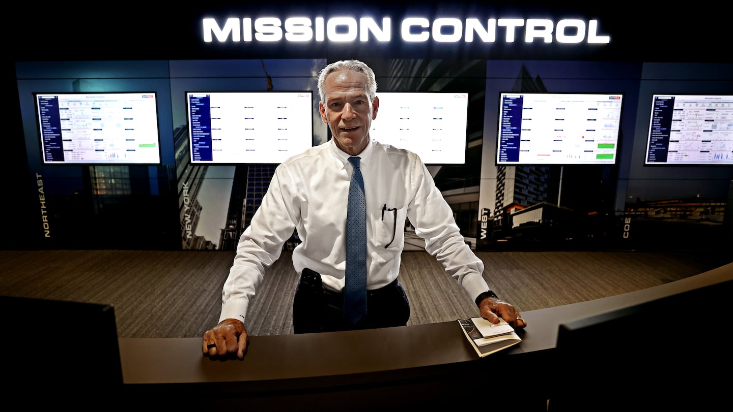 Suffolk Construction CEO John Fish in the new "Mission Control Center" used to monitor his company's projects underway around the world.
