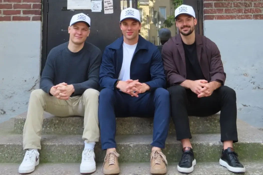 Endo's founders founders sit together on a stoop.